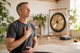 Man meditating in front of a gong @ki-generated