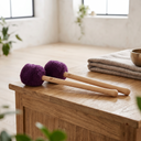 New products from ollihess: two gong mallets with purple heads on a wooden table in a brightly lit room